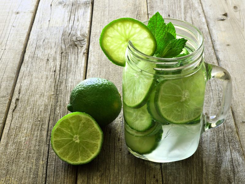 39206740 - detox water with lime and cucumbers in a mason jar against a rustic wood background
