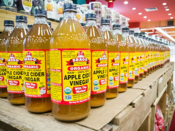 apple cider vinegar glass bottles on shelf