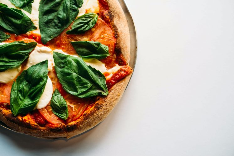 pizza with basil cheese white background favorite food