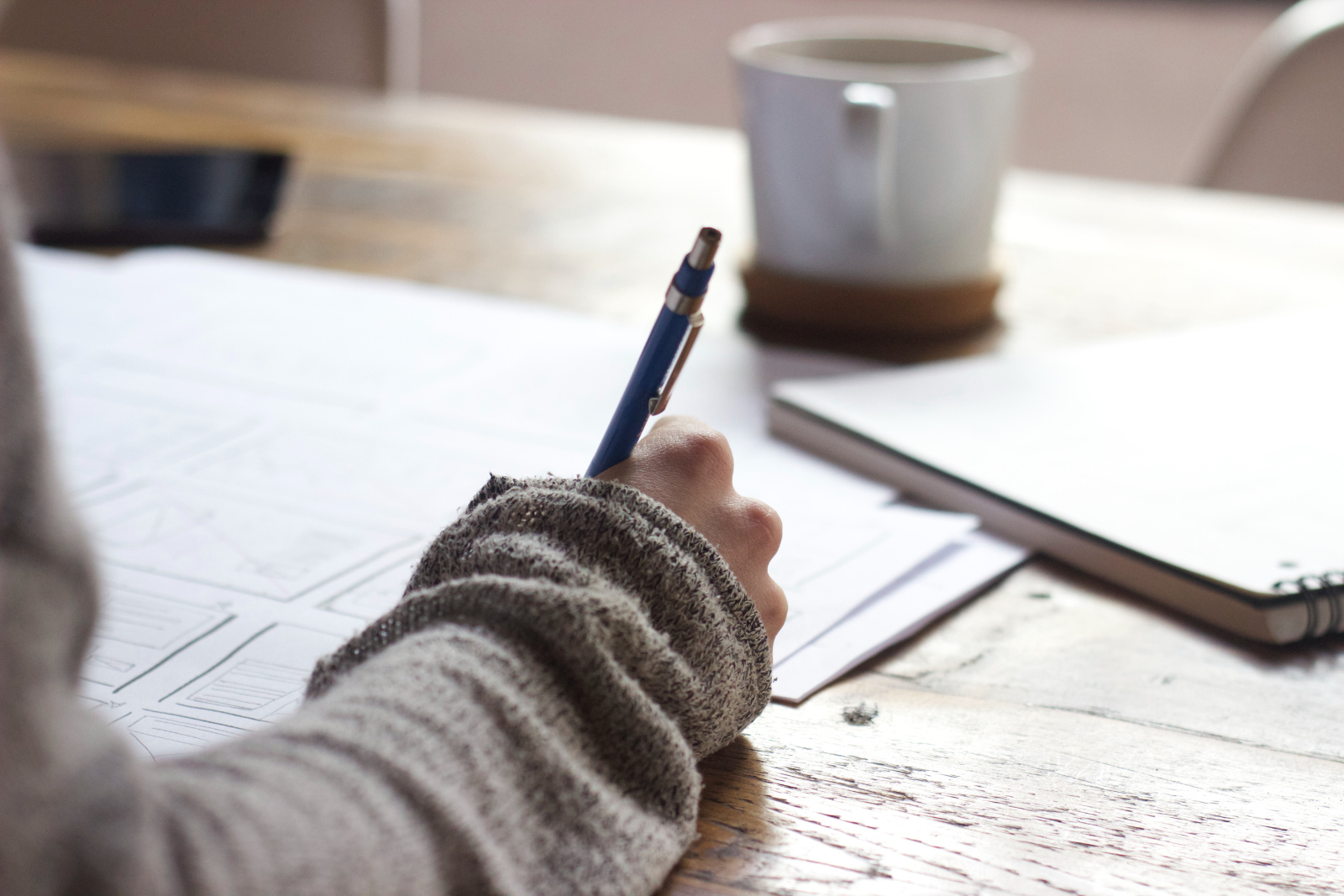 writing studying with coffee in white mug