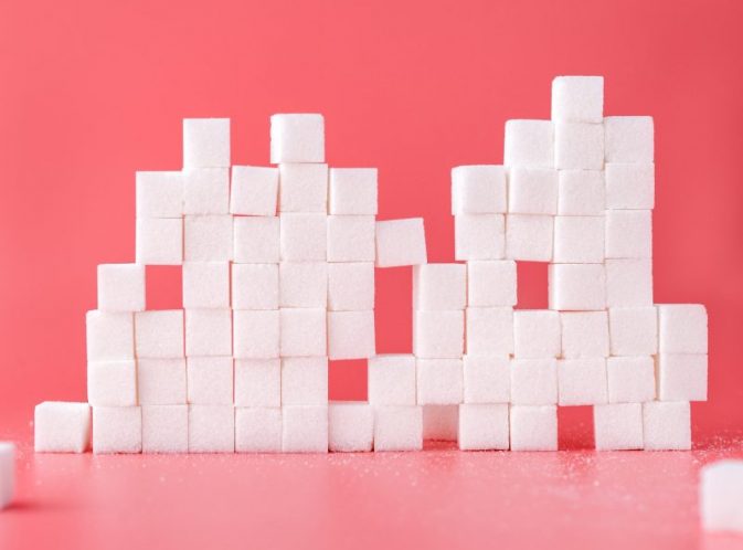 sugar cubes stacked pink background