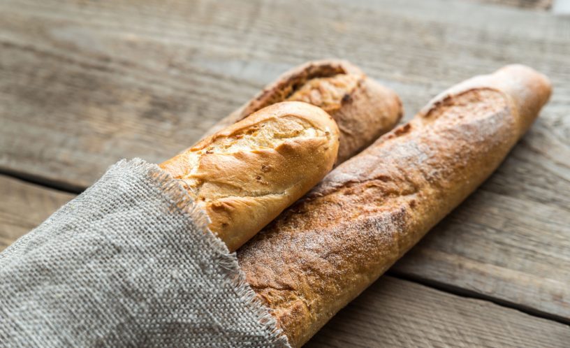 3 baguettes bread on wooden backrground