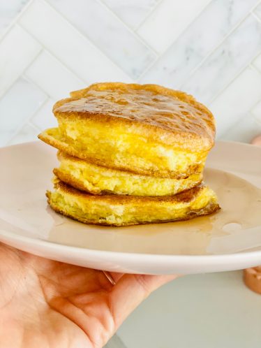 fluffy keto souffle pancake stack on a white plate
