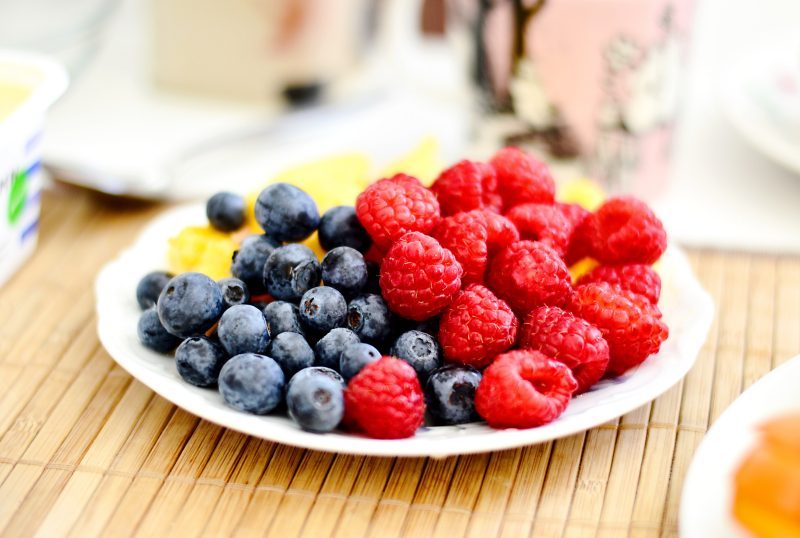 blueberries and raspberries on a white plate