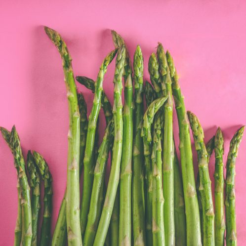 asparagus stalks on pink background