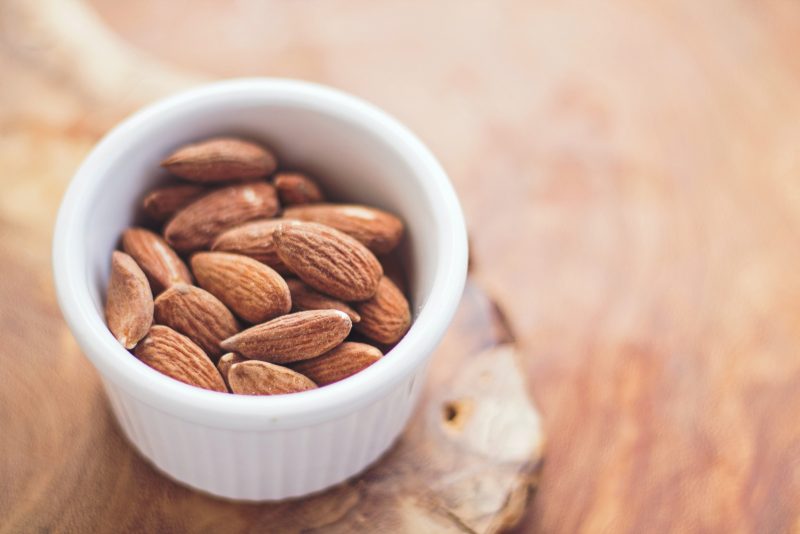 small serving almonds in white ramekin on cutting board