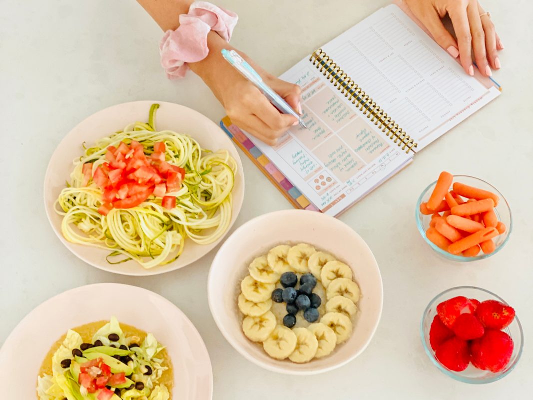 bowls of healthy food zoodles banana oatmeal berries carrots meal prep pad