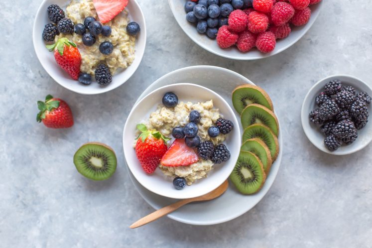high fiber oatmeal fruit berries in white bowl