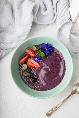 blogilates 90 day journey pb j smoothie bowl in teal bowl with fresh fruit