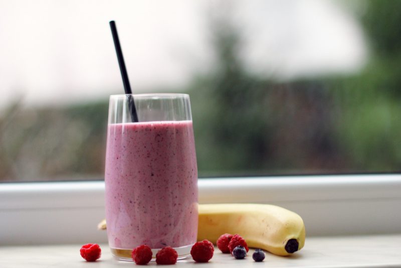 smoothie in glass with berries and banana