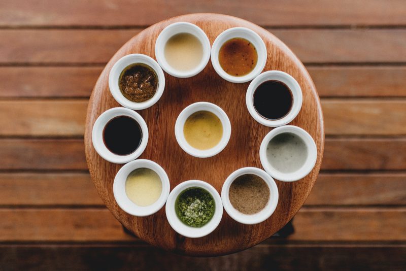 tray with sauces in ramekins on wooden table