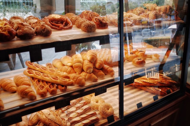 display case with breads pastries carbs bakery