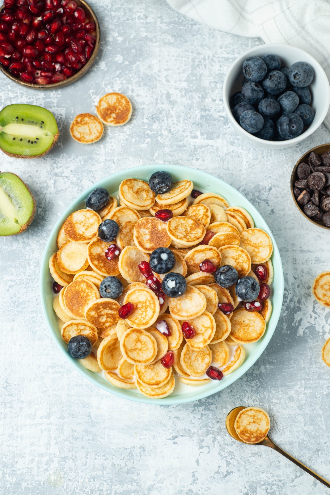 blogilates cassey ho mini cereal pancakes in a bowl with fresh fruit