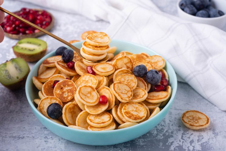 blogilates cassey ho mini cereal pancakes in a bowl with fresh fruit
