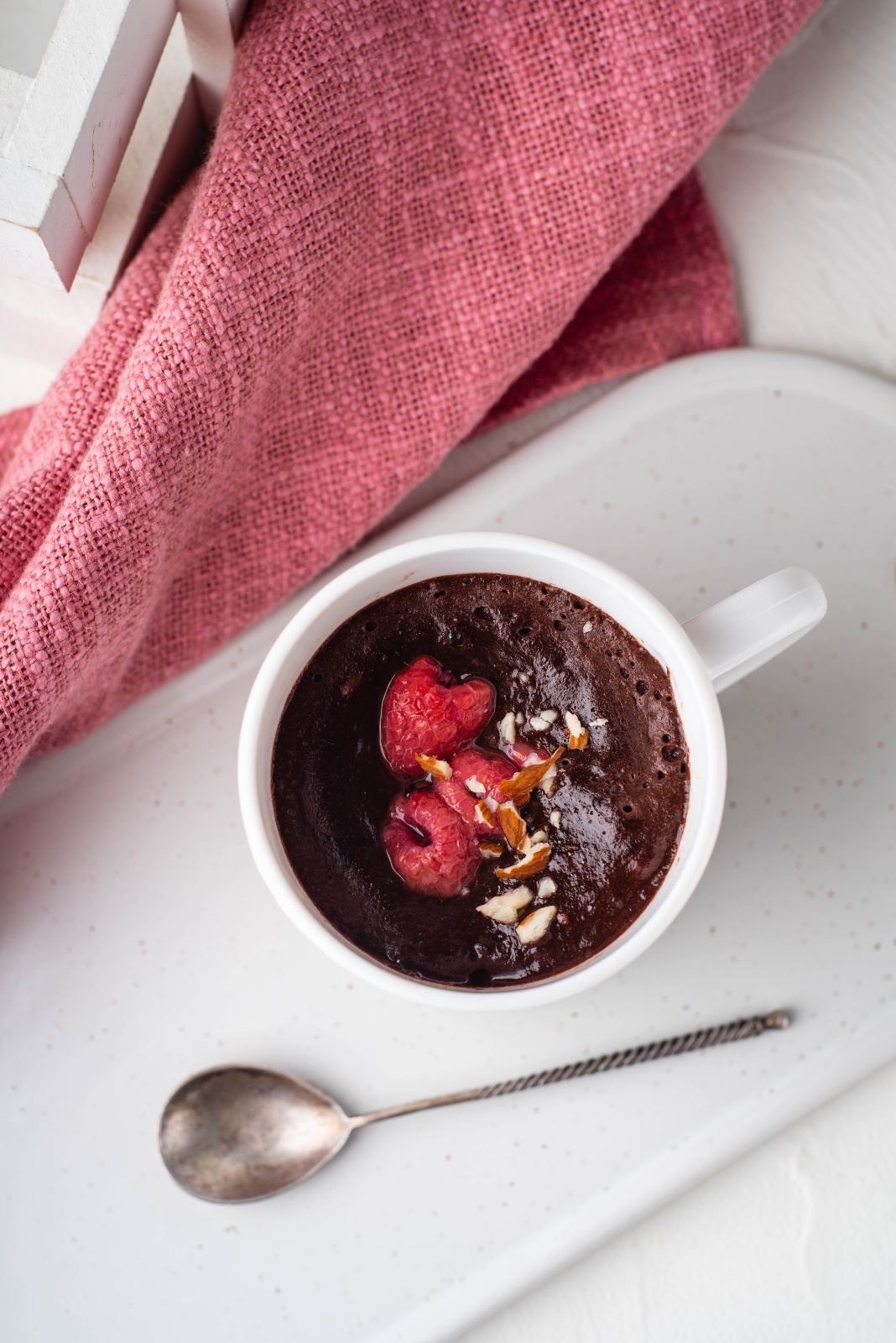 chocolate mug cake topped with raspberries in white mug blogilates cassey ho 90 day journey meal plan
