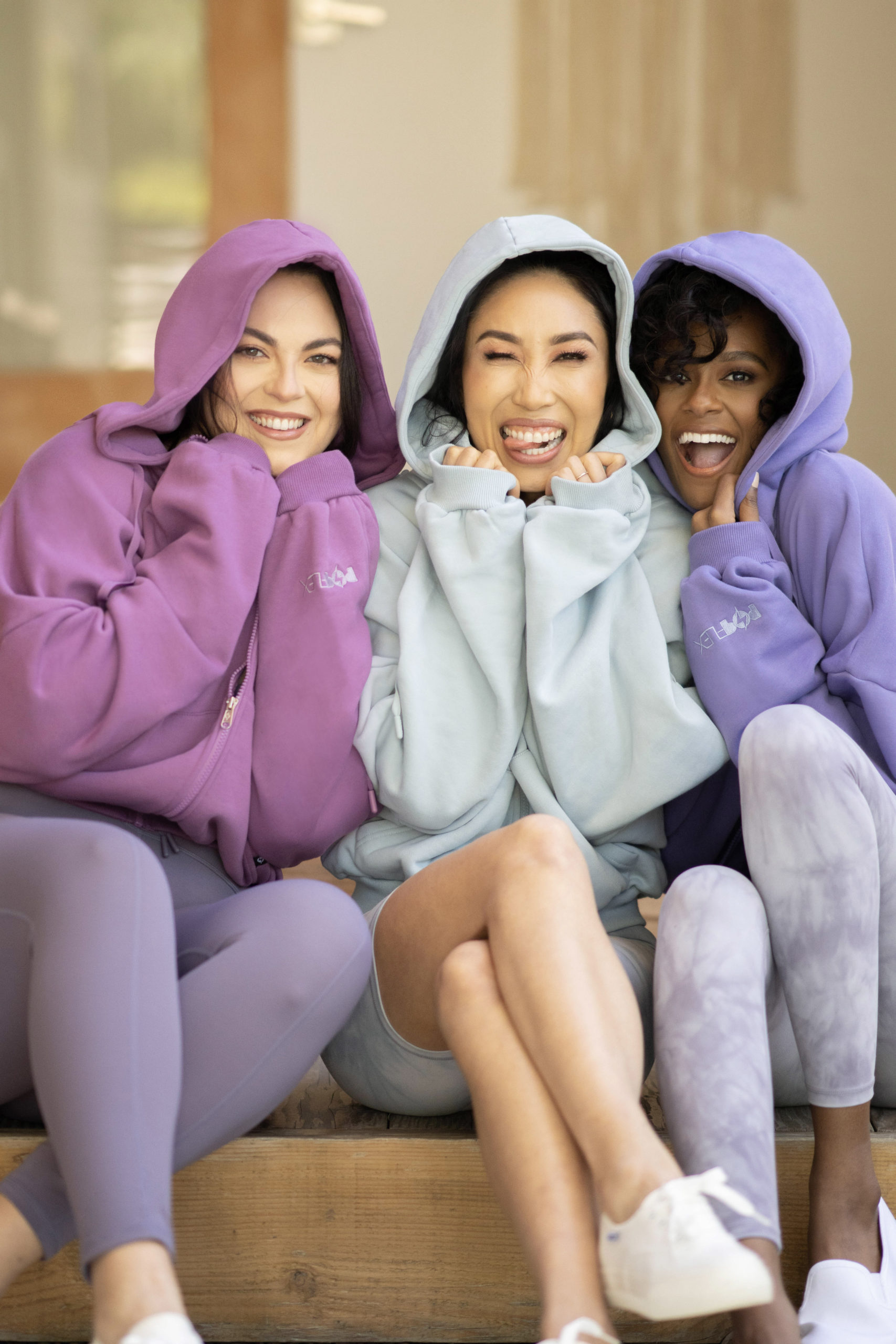 models and cassey ho wearing popflex marble collection cloud hoodie in plum ice blue and blue violet