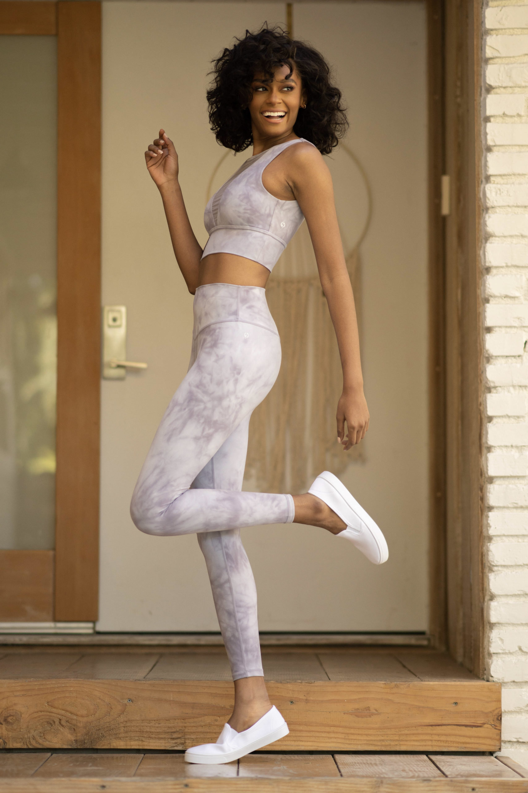 model wearing popflex marble vivid crop top bra and sculpt legging lavender side full view