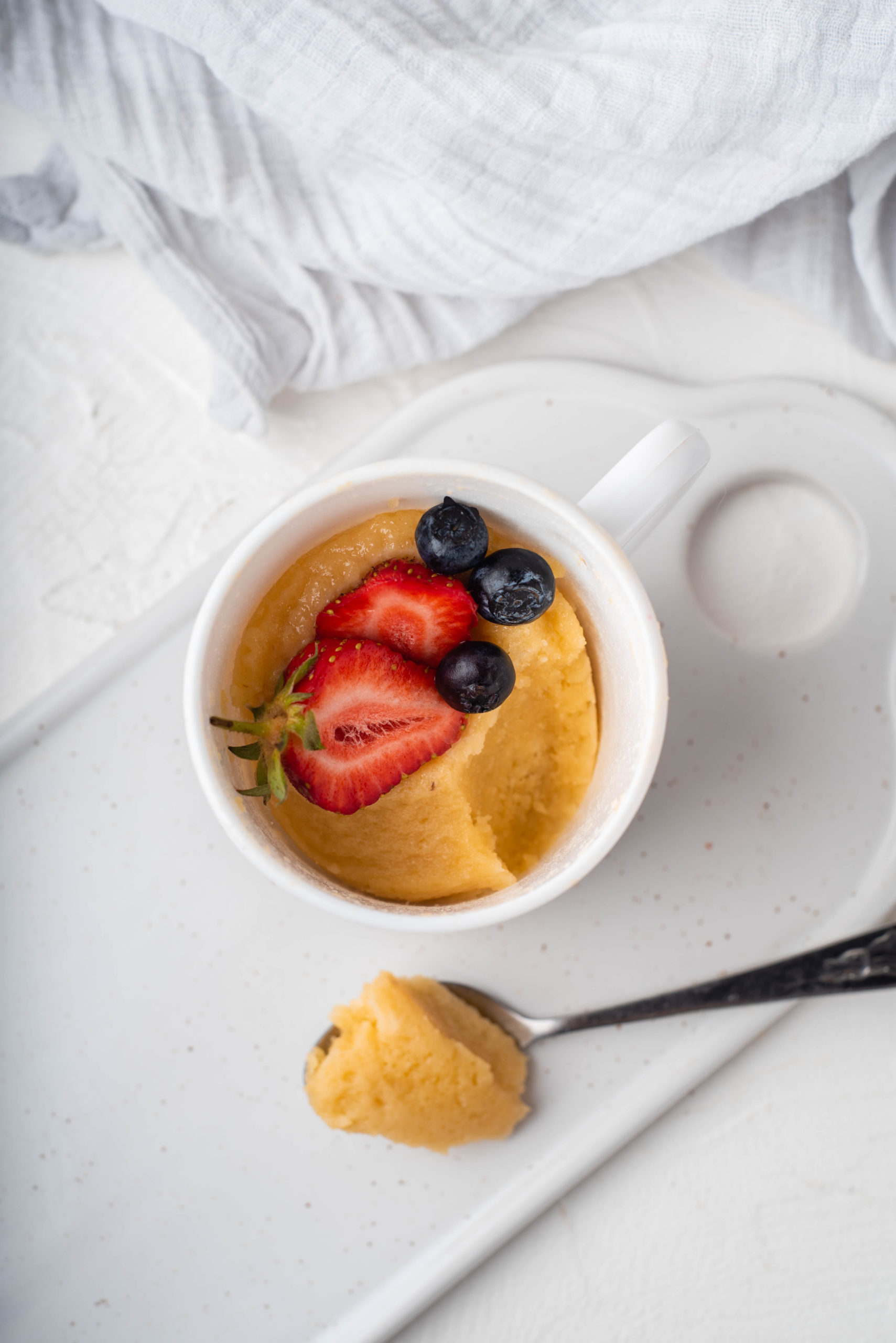 top 10 breakfast recipes peanut butter muffin in white mug topped with berries