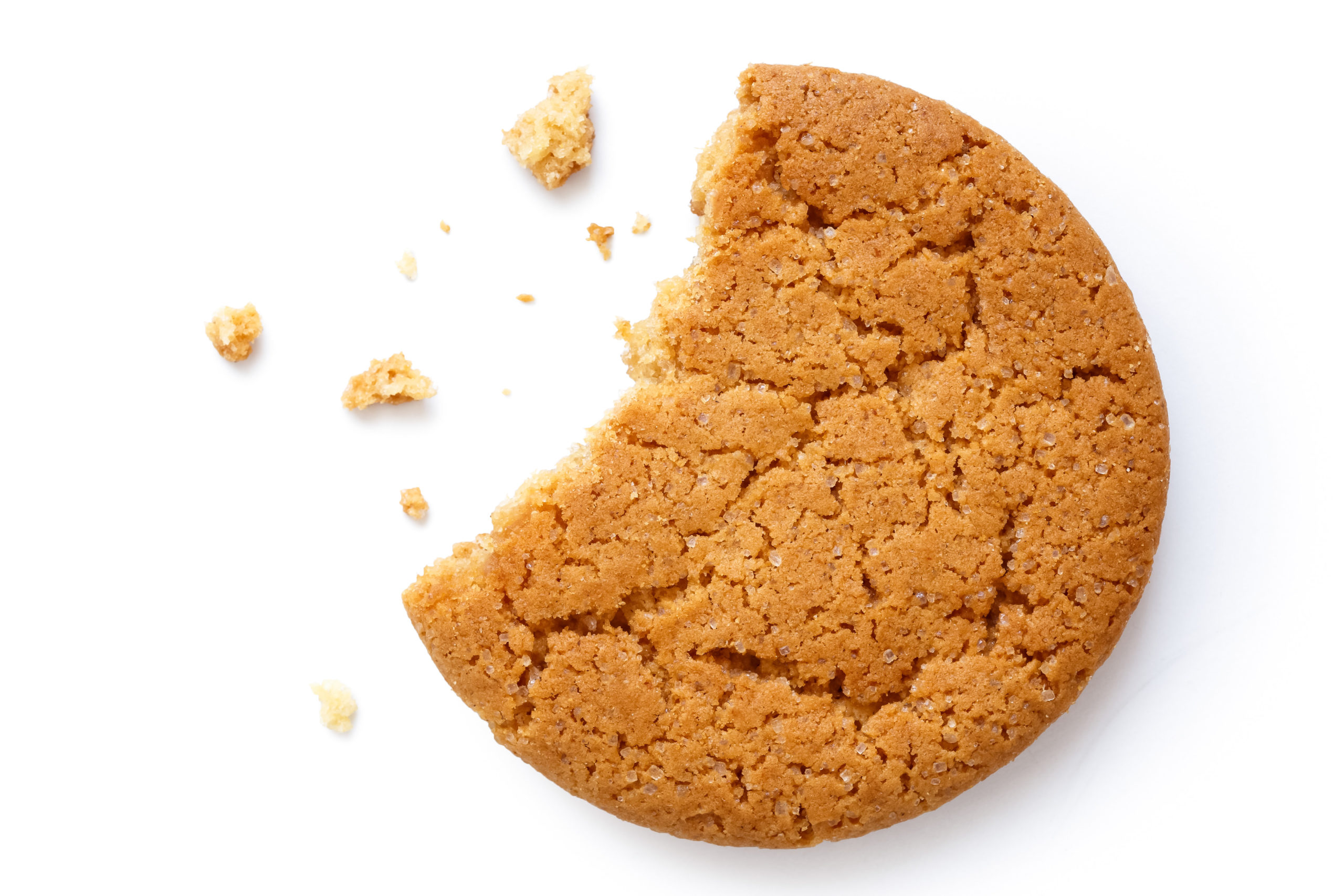 ginger cookie with bite taken out and crumbs