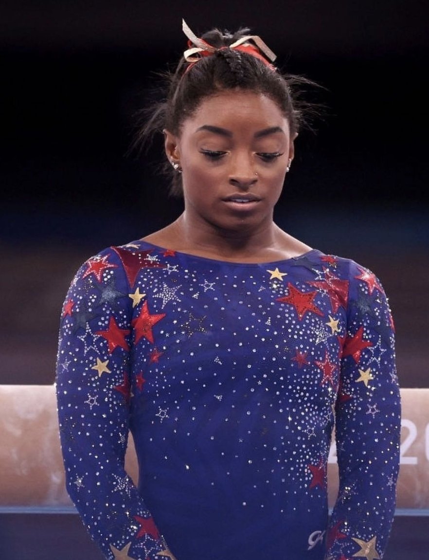simone biles in blue leotard with red and silver stars olympics tokyo
