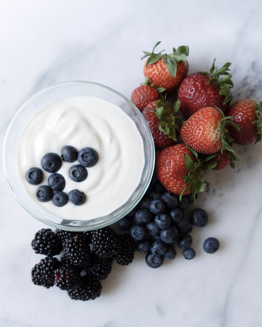 coconut fruit dip with blueberries and strawberries