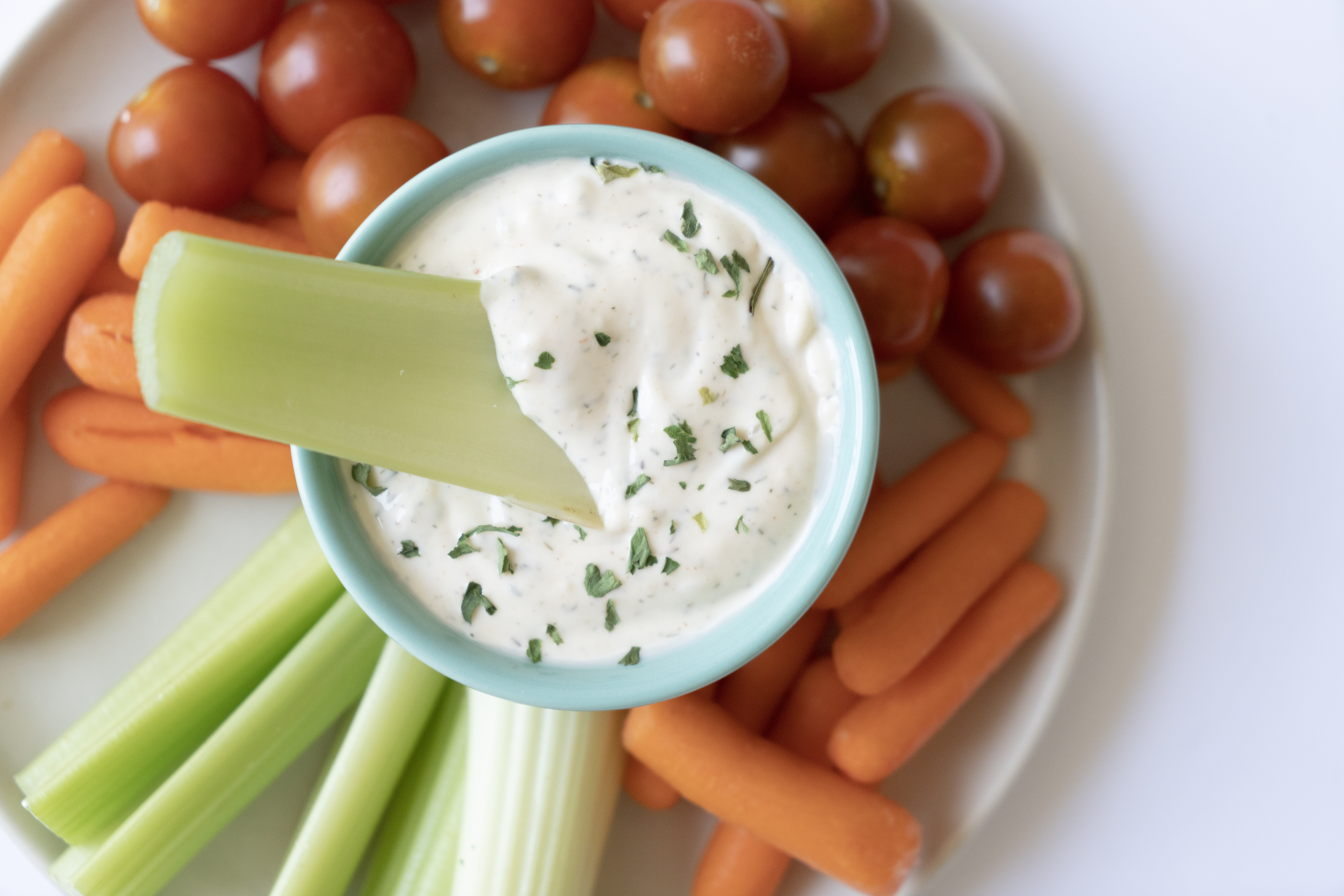 close up look at dairy free ranch with celery dipping