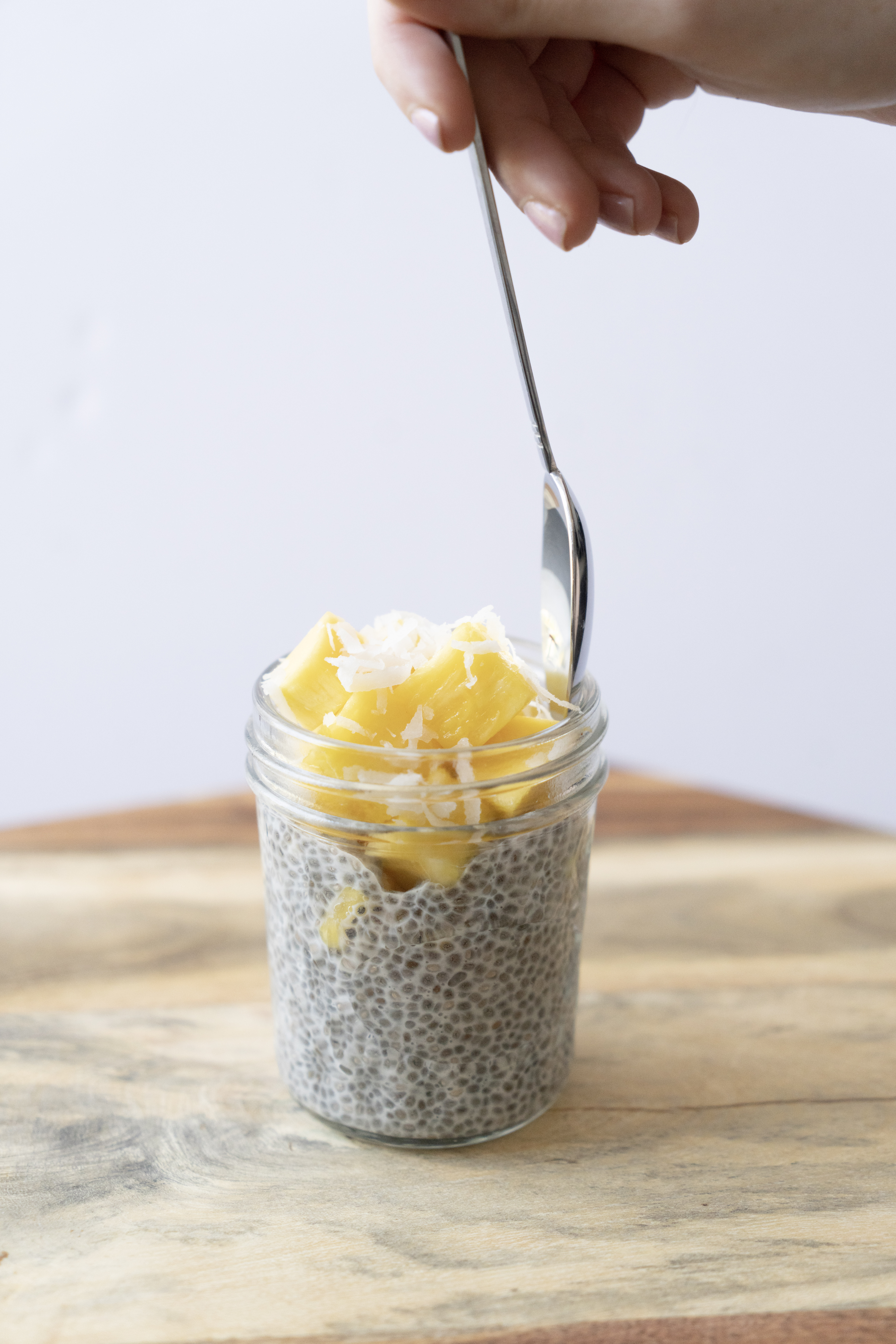 spoon in tropical chia pudding