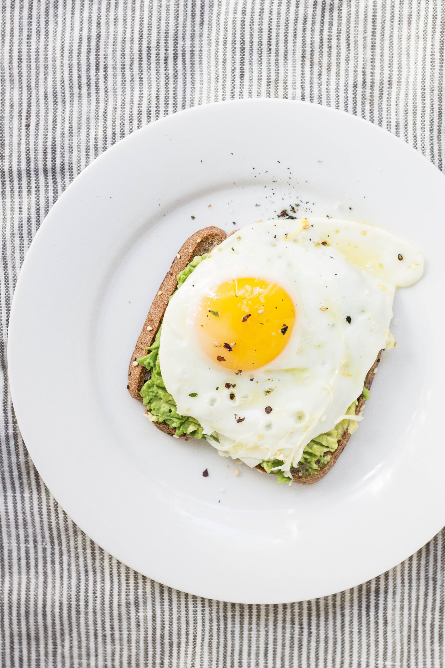 avocado toast with soft cooked egg on top