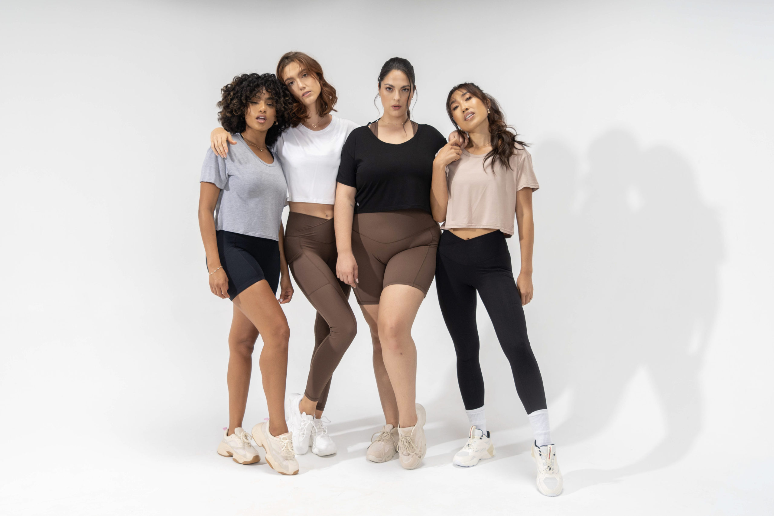 popflex basics collection group shot explore tee heather grey, black, white, and taupe