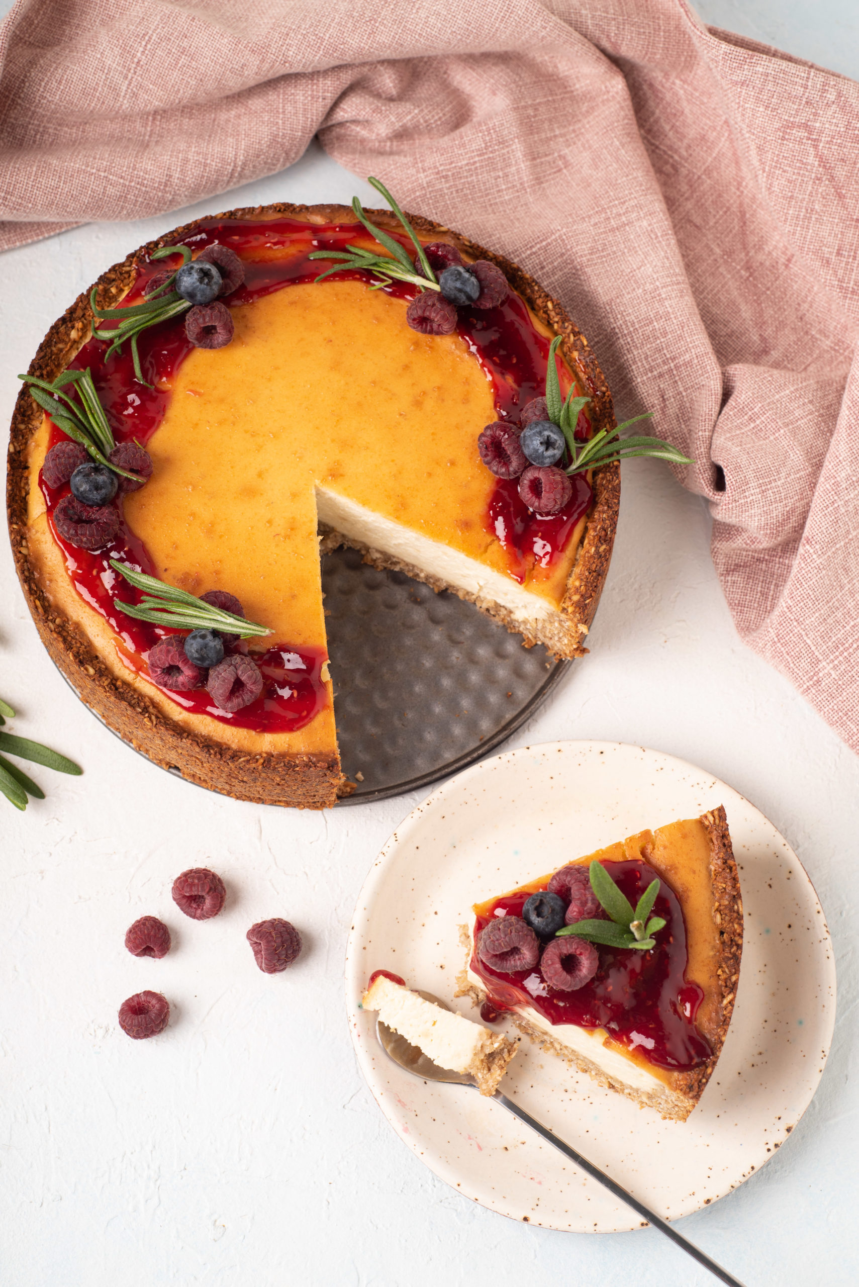 vegan tofu cheesecake topped with berries with slice cut