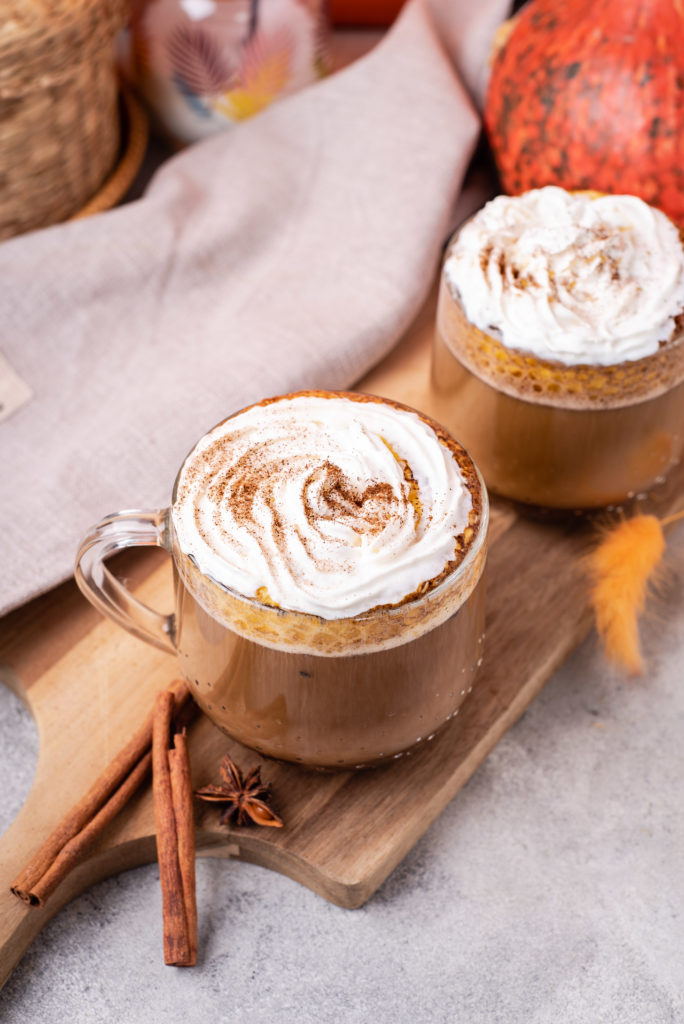 blogilates healthy pumpkin spice latte in clear mug topped with coconut whipped cream