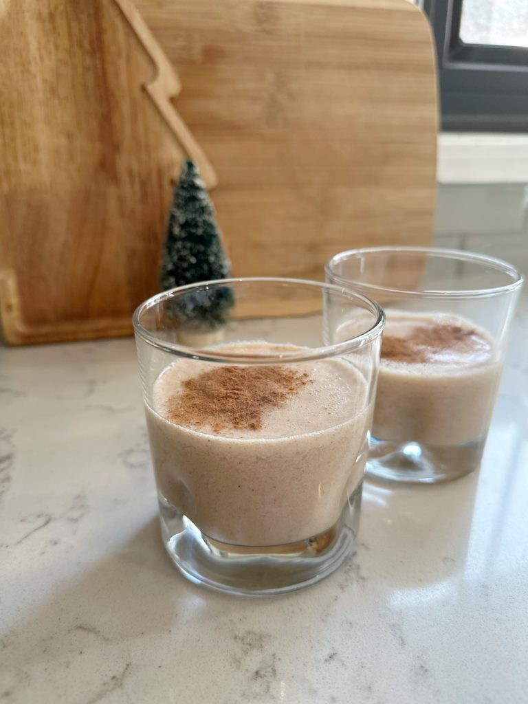 two glasses of almond eggnog dairy-free eggnog with cinnamon sprinkle