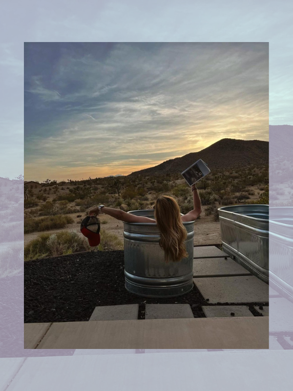 woman in cold plunge ice bath tub with mountains