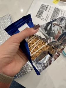 Cassey Ho holding the snickerdoodle Blogilates macromolecule  bar