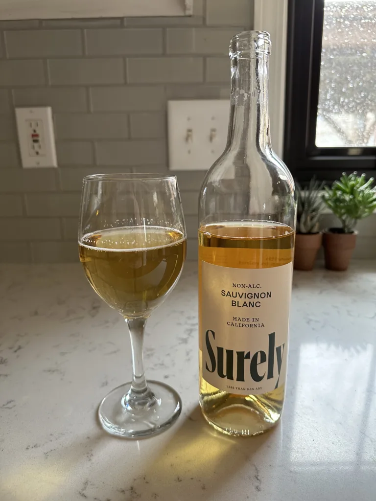 surely sauvignon blanc non-alcoholic white wine poured into a wine glass 