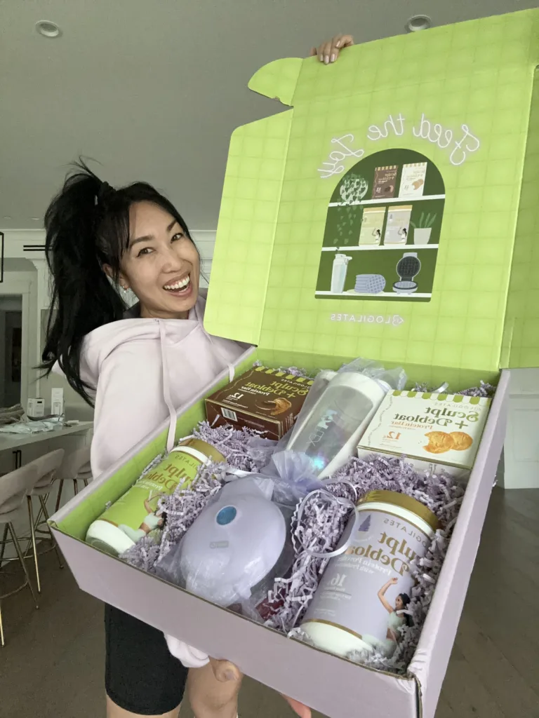 Cassey Ho holding influencer PR box with new Blogilates protein powder and protein bars