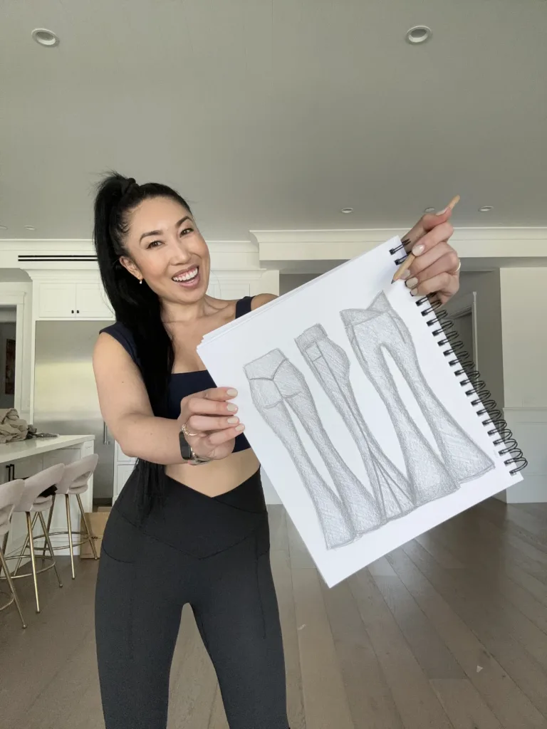Cassey Ho wearing the new Bell Bottoms while holding up her original design sketch