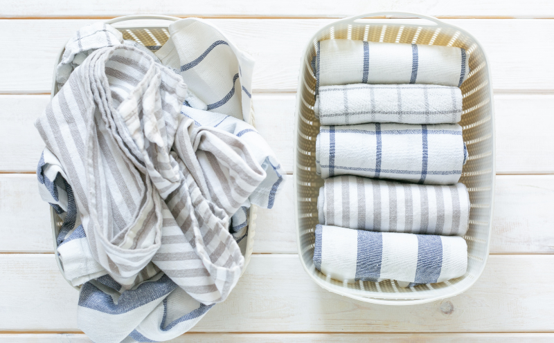basked of unfolded towels next to basket of neatly folded towels