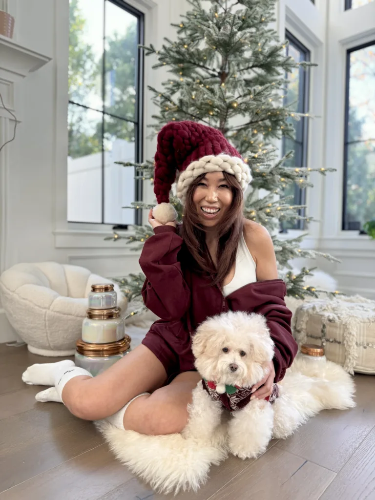 cassey ho wearing popflex cloud romper in red wine with christmas hat and tree sweatshirt romper